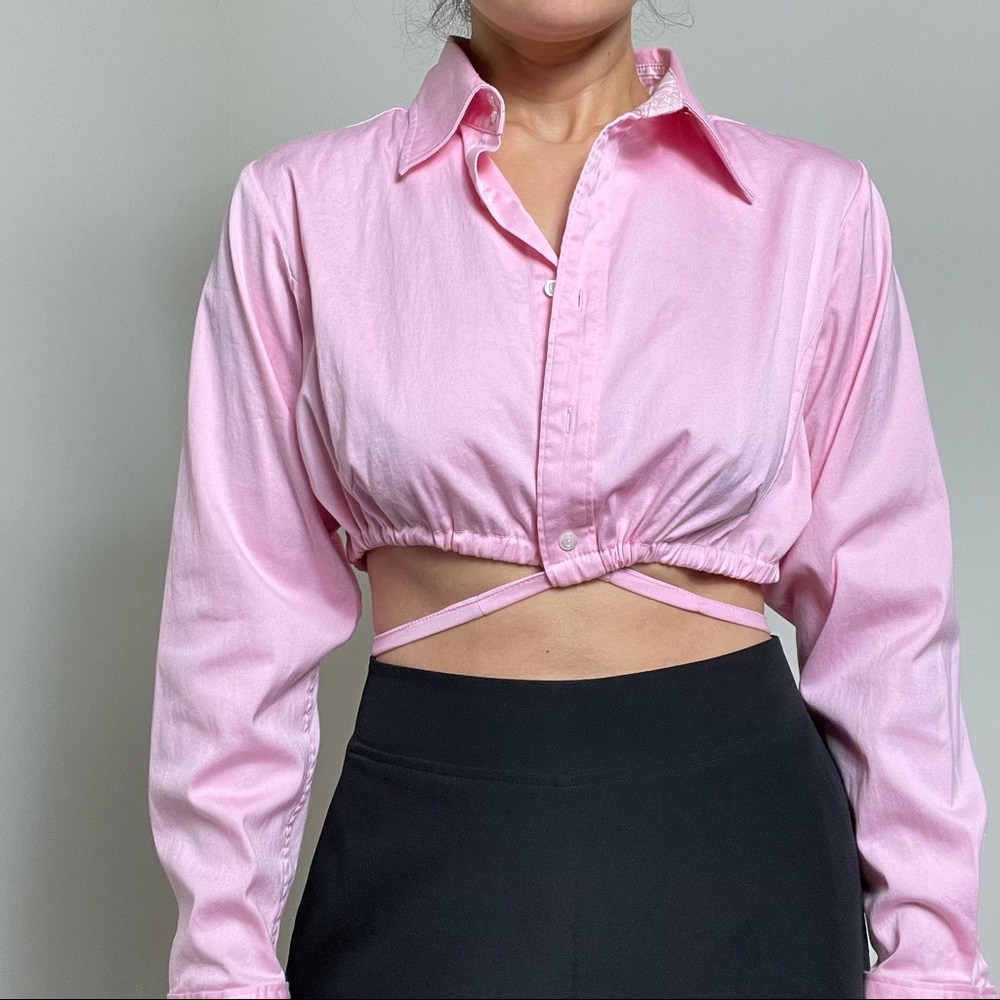 Cropped button down with straps around the waist. Size L. Runs small.